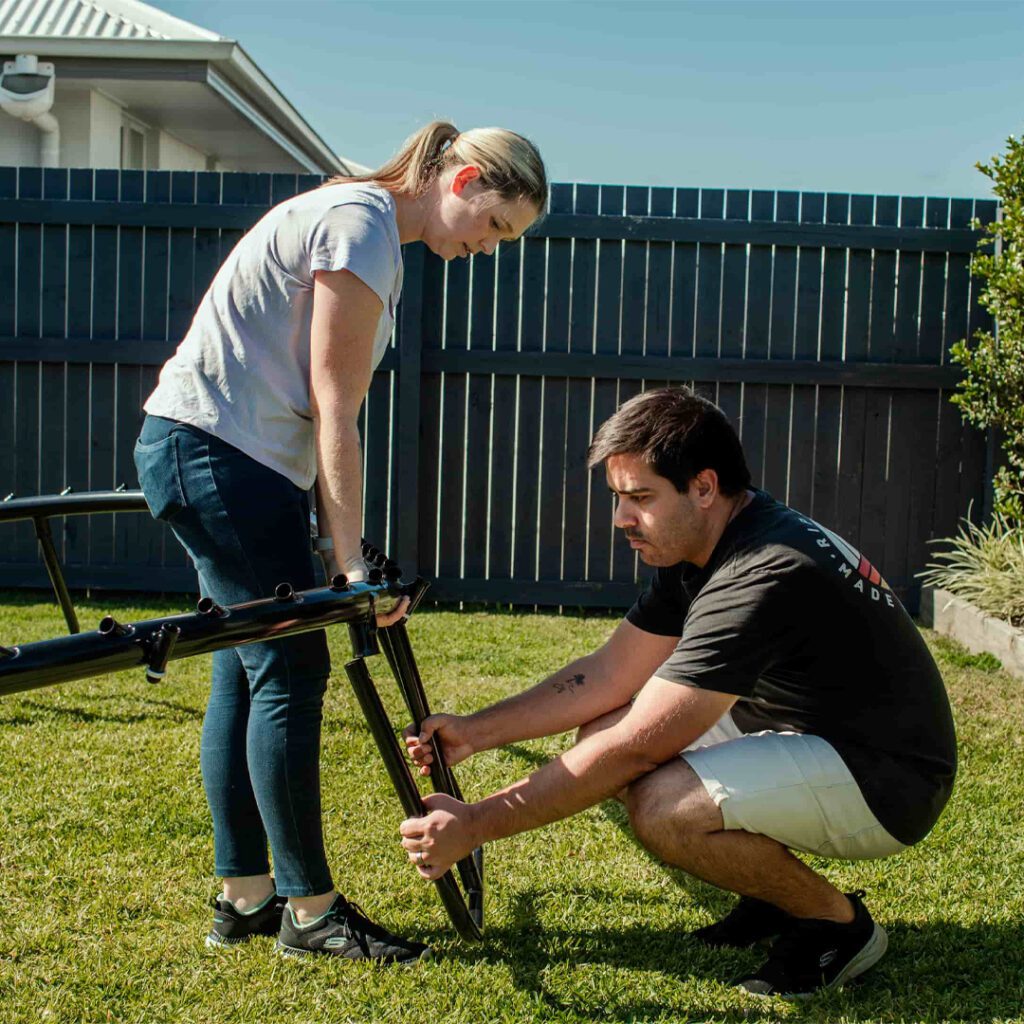 Man Woman Installing Trampoline Frame - supertramp.co.uk