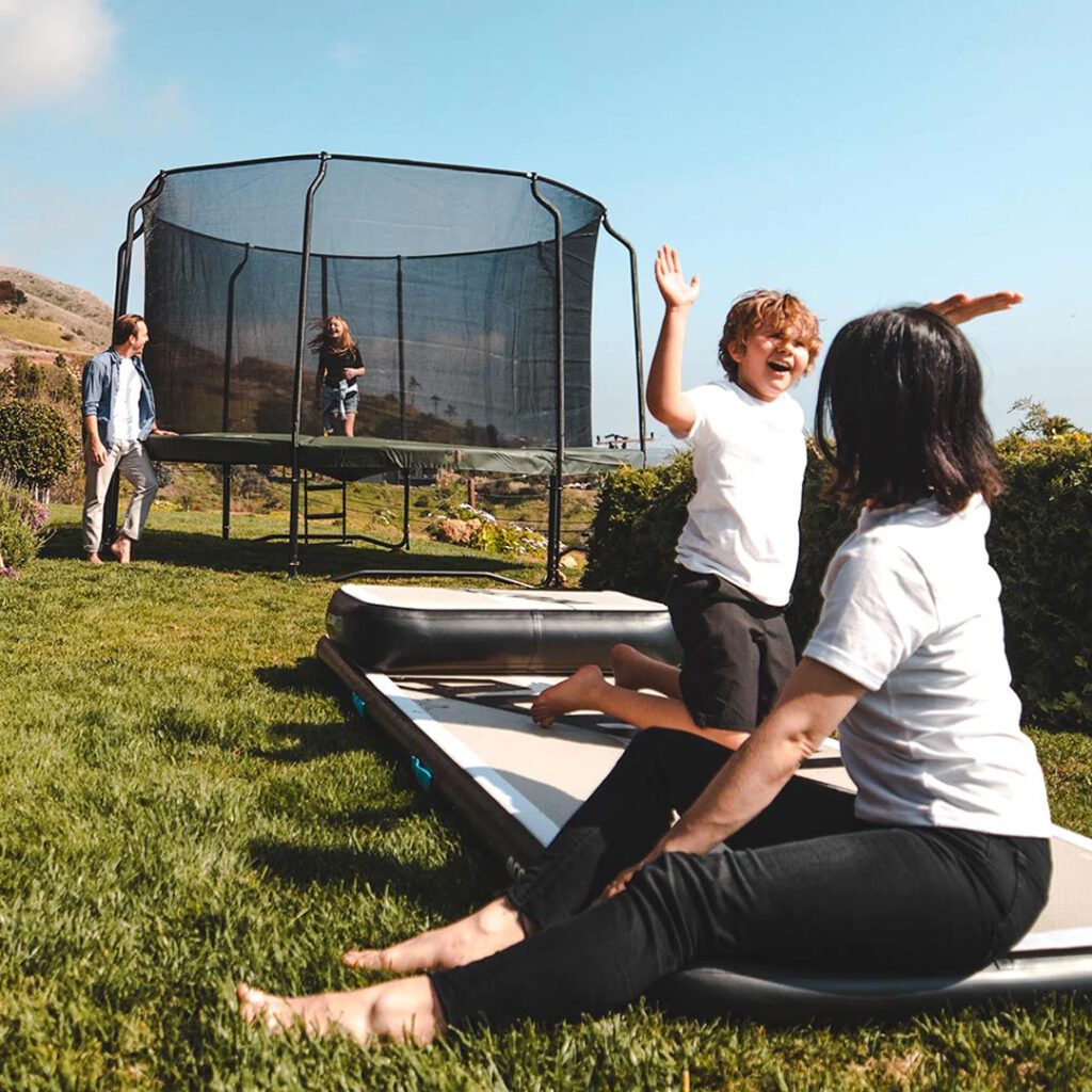 Family Enjoying Above Ground Round Trampoline - supertramp.co.uk