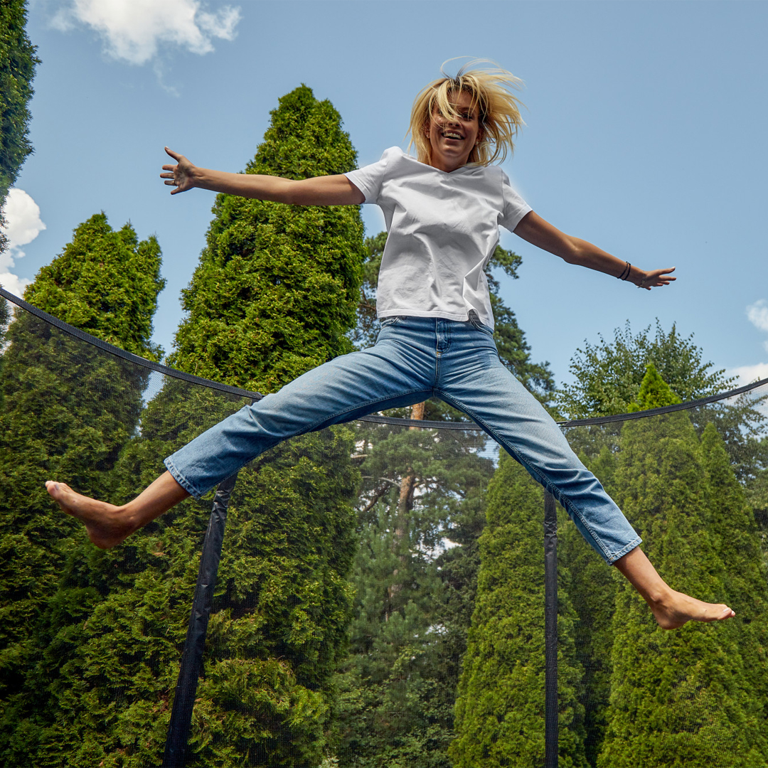 Women Wear White Shirt Jumping on Trampoline - Akrobat UK