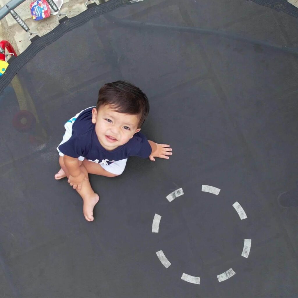 Little Child sitting on Round Trampoline - supertramp.co.uk