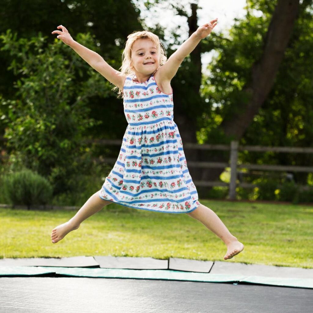 Girl Jumping on Inground Trampoline - supetramp.co.uk